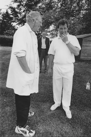 Umpire Bill Oliver consults Keith Emery overseen by Ian Macaulay