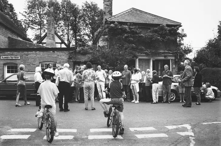 30 August 2002. The Day the Shop Closed. Julia Walers, far right, waits to make a floral presntation to Robin Taylor (centre)