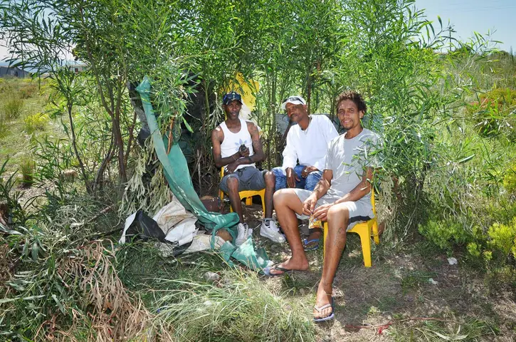L-R. Roberto Adams, Sidwill Witbooi & Gredwill Jacobs chilling at the dagga den. Railton. 2019.