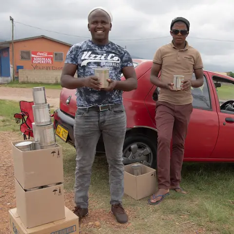 Zwelibanzi & Molekaane sell damaged tins of fruit from the Ashton cannery where they work. Railton, Swellendam 2020