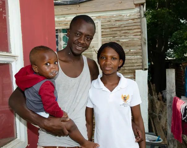 Francis Mutero & Caroline Bilsom with their son Terdai. Railton. 2019