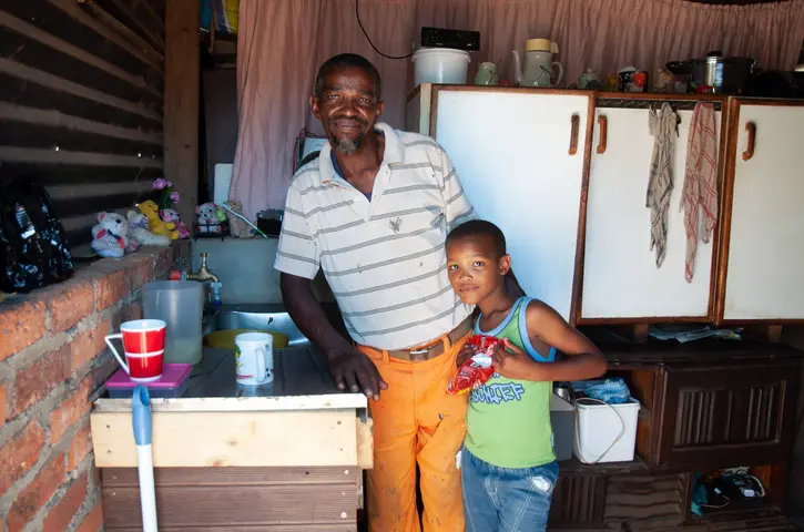 Jacobus Jack with son Jerome at home in Railton. 2019
